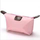 a pink cosmetic bag with a brown handle