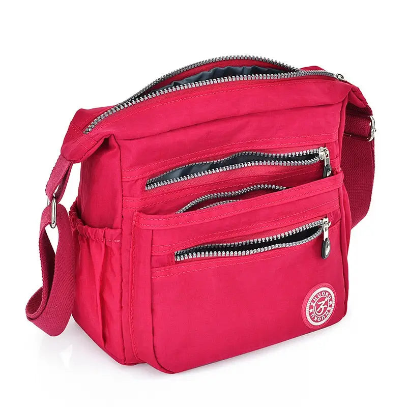 a pink fanny bag with zippers and a zipper