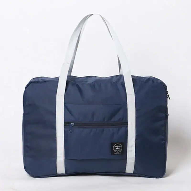 a navy duff bag with white trim and a white handle