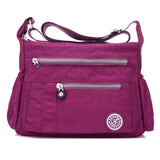 a purple purse with zippers and a zippered pocket