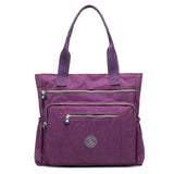 the purple bag is a small, purple purse with a zipper closure