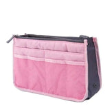 the pink and grey cosmetic bag is shown with a zipper closure