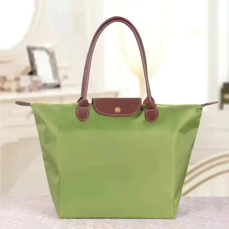 a green tote bag on a counter