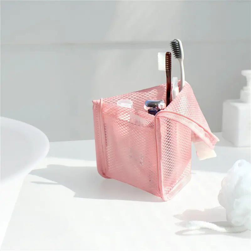 a pink bag with a toothbrush and toothbrush