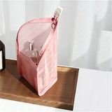 a pink bag sitting on top of a wooden table