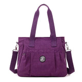 the purple bag is a small, purple purse with a zipper closure