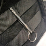 a black backpack with a metal handle
