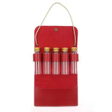 a red leather wine carrier with four bottles