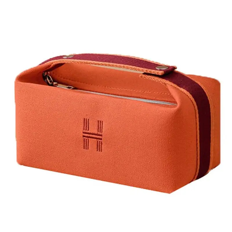 a small orange case with a zipper closure