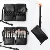 a close up of a person holding a black bag with makeup brushes