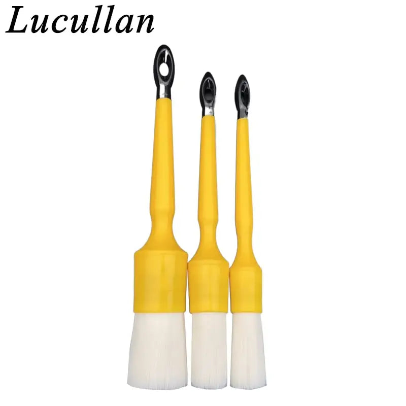 two yellow paint brushes with white bre