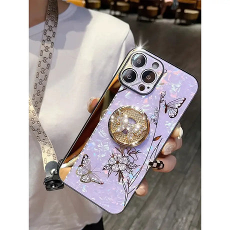 a woman holding a phone case with a flower design