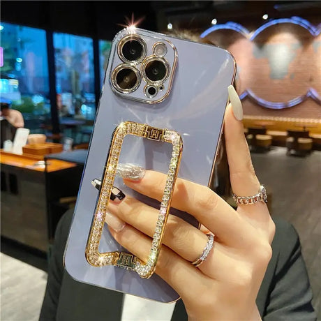 a woman holding a phone case with a ring on it