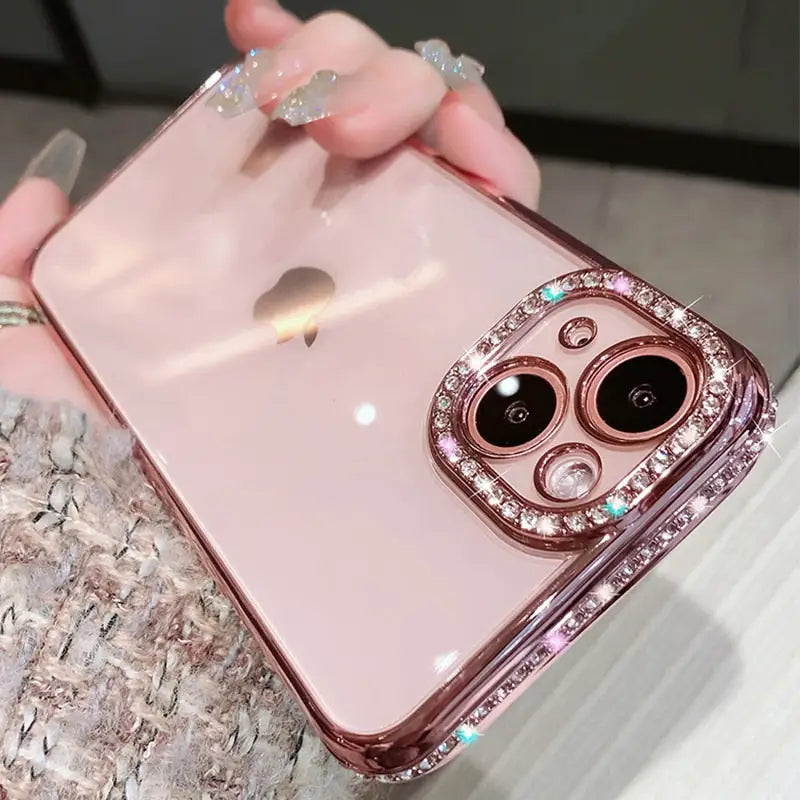 a woman holding a pink iphone case with a diamond ring