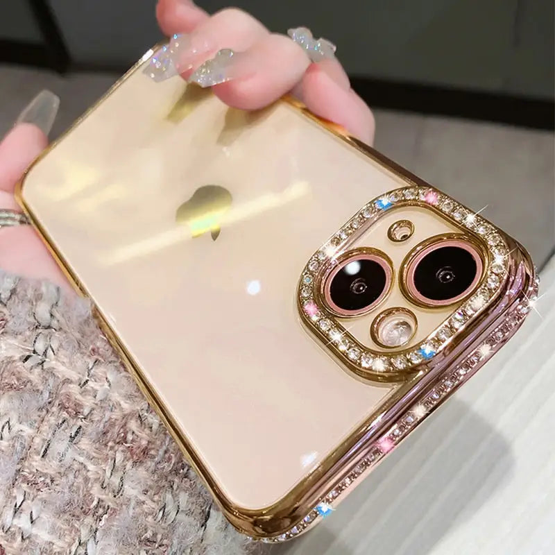 someone holding a gold iphone case with a diamond owl on it