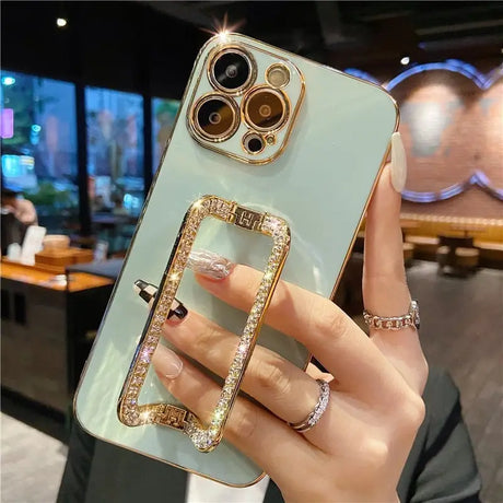 a woman holding a phone case with a ring on it