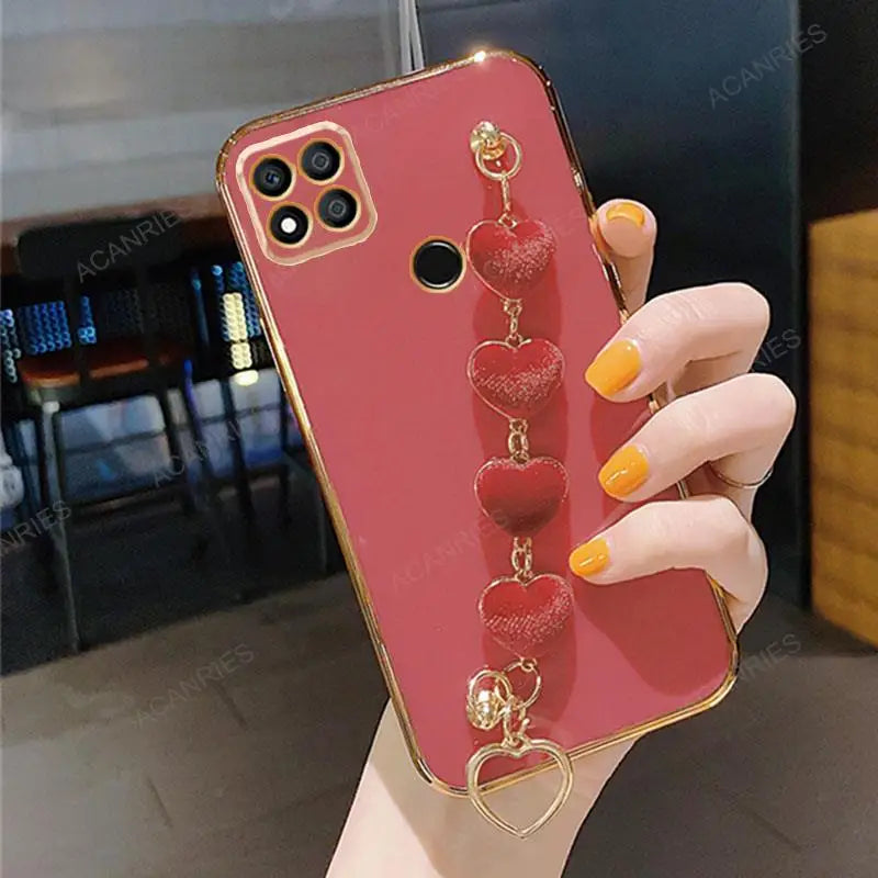 a woman holding a red phone case with a heart shaped phone holder