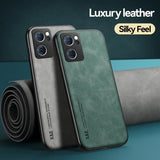 a pair of green leather iphone cases sitting next to a rolled up roll of fabric