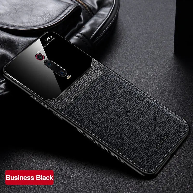 a close up of a black leather case with a black phone