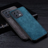 the back of a blue leather case with a black leather cover