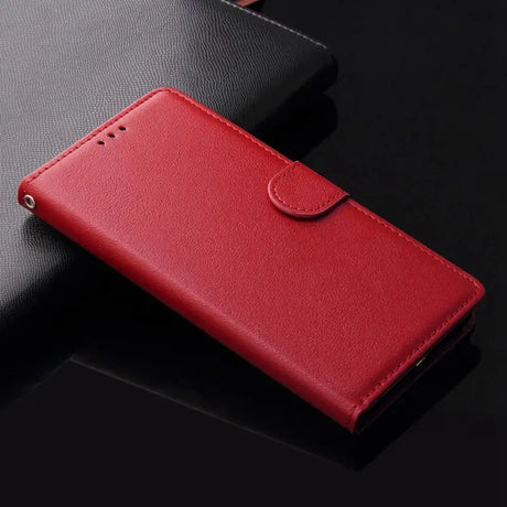 a close up of a red leather case on a black surface