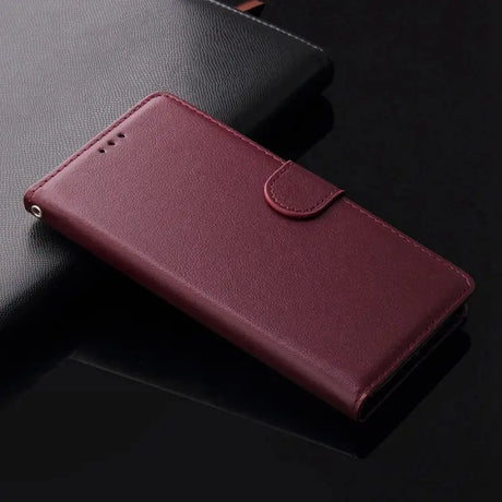 a close up of a red leather case on a black surface