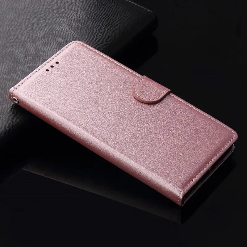 a pink leather wallet case with a metal ring