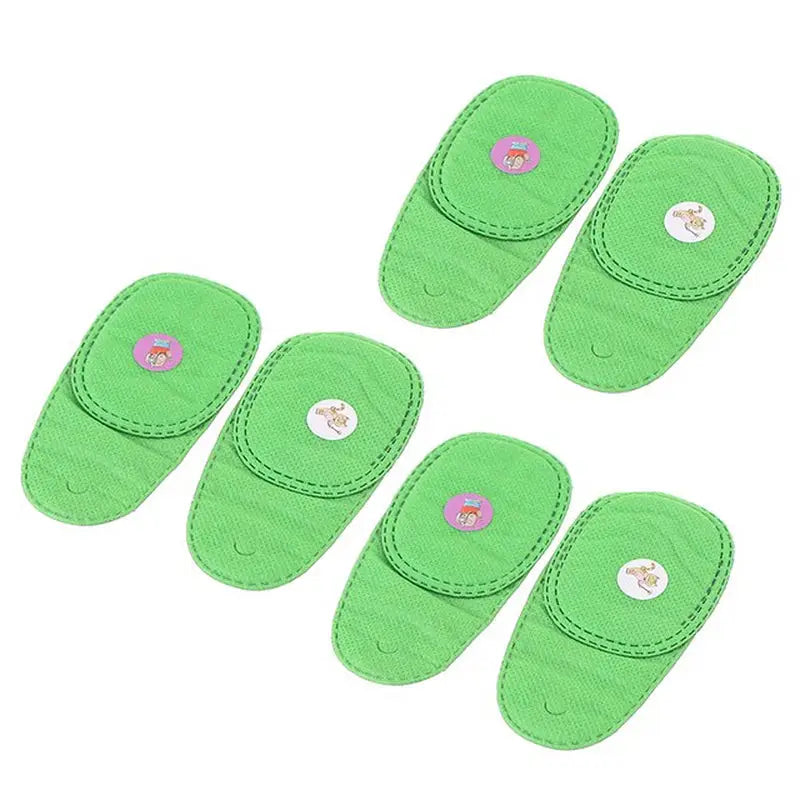 a set of four green slippers with a pink flower on the top