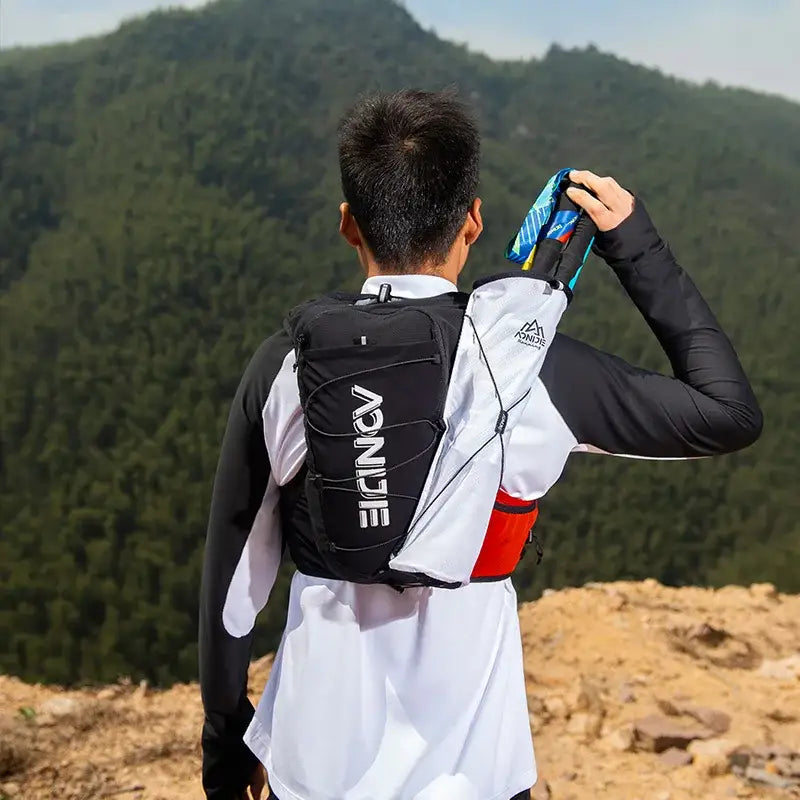 a man wearing a backpack looking at the mountains