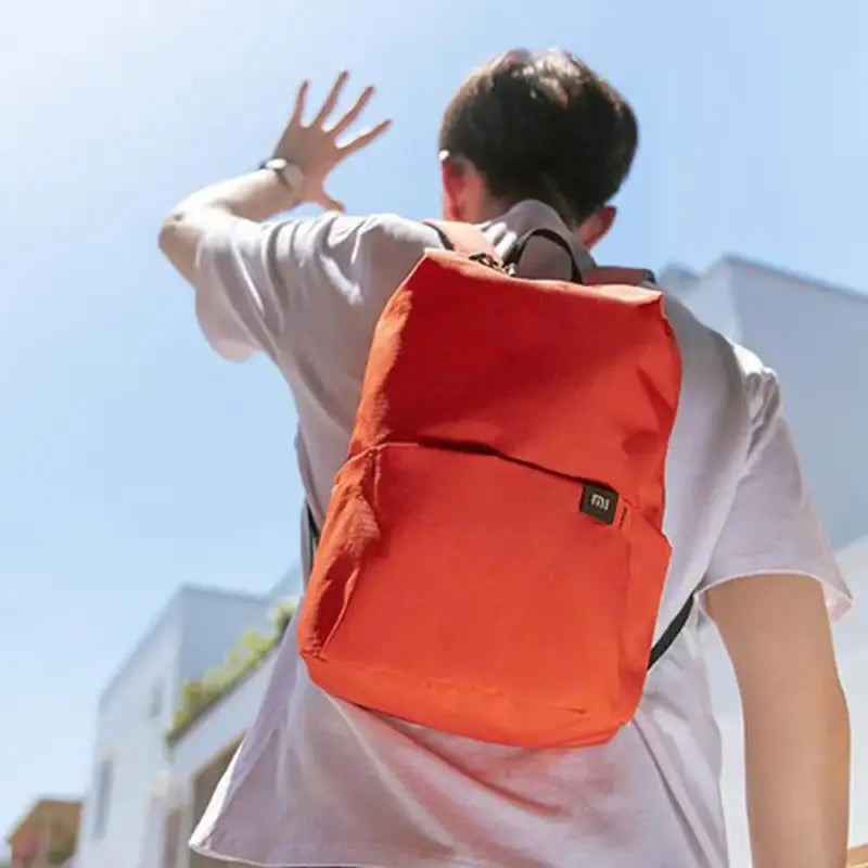 a man with a backpack walking down the street