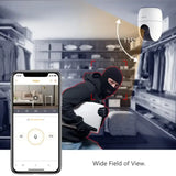 a man in a black hood and hoodie is using a smartphone to scan a home security camera