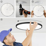 a man using a circular light fixture to install the light fixture