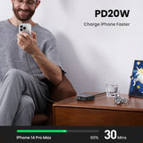 A man sitting on a couch holding a cell phone