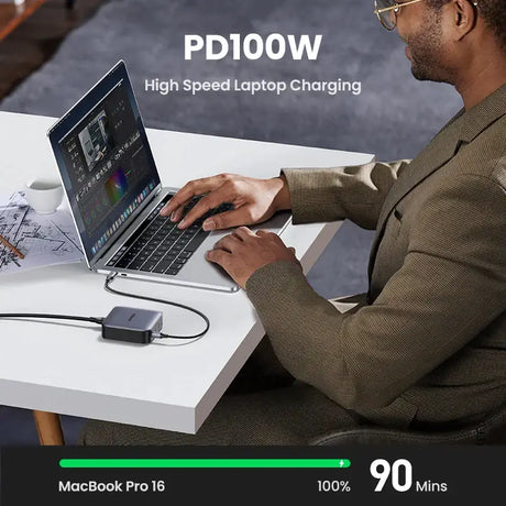 A man sitting at a desk using a laptop