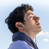 Man wearing in-ear headphones.