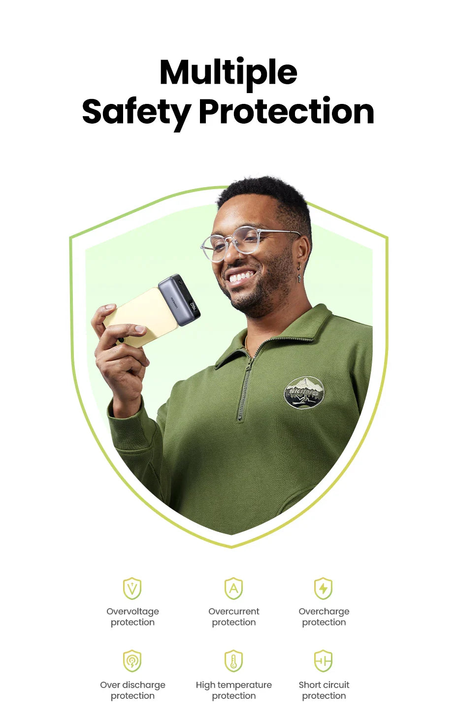 Smiling man in a green polo shirt holding a credit card.