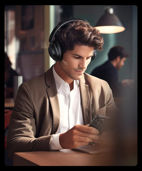 Man wearing headphones and a tan suit jacket.