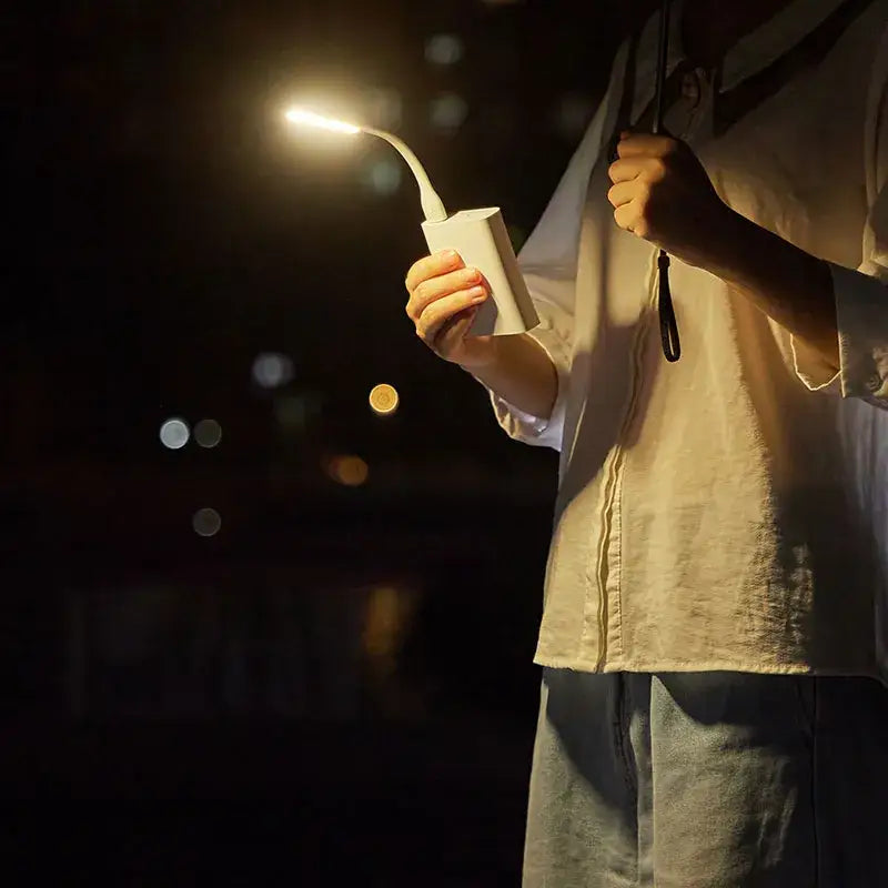 a man holding a lit candle in his hand