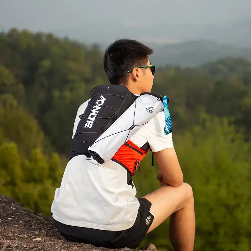 a man sitting on top of a mountain