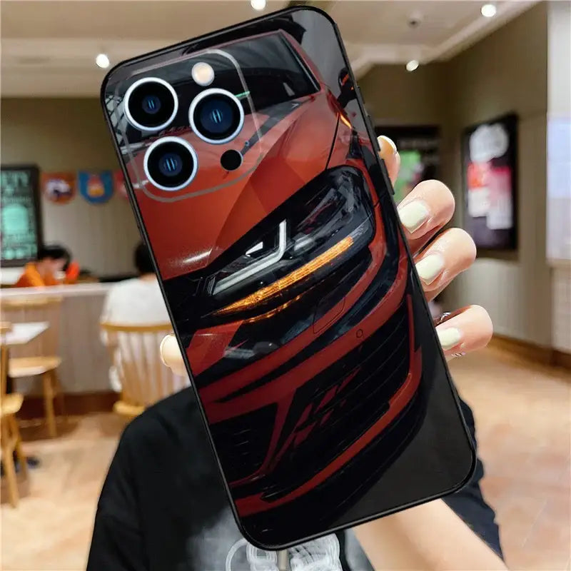 a man holding up a phone case with a car design