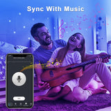 a man and woman playing music on a bed