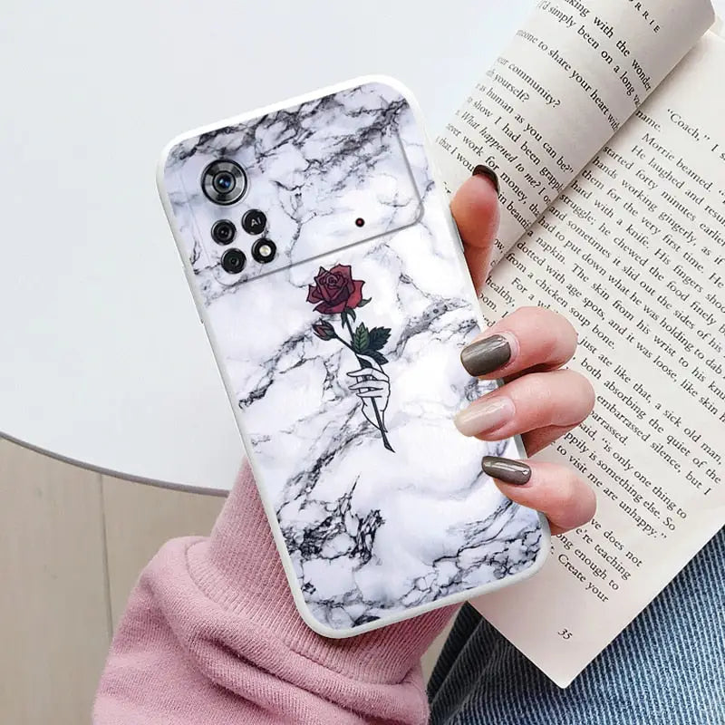 someone holding a phone case with a rose on it