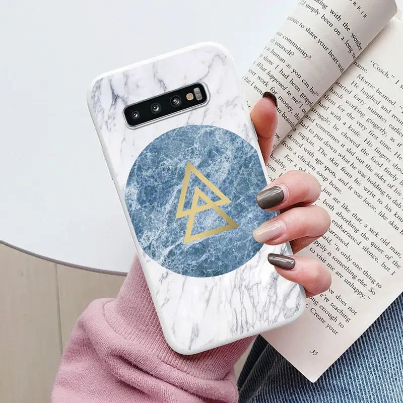marbled phone case with a triangle and a gold triangle on it