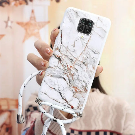 a woman holding a white phone case with marble pattern