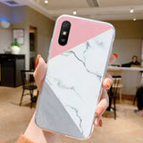 a woman holding a white and pink marble phone case