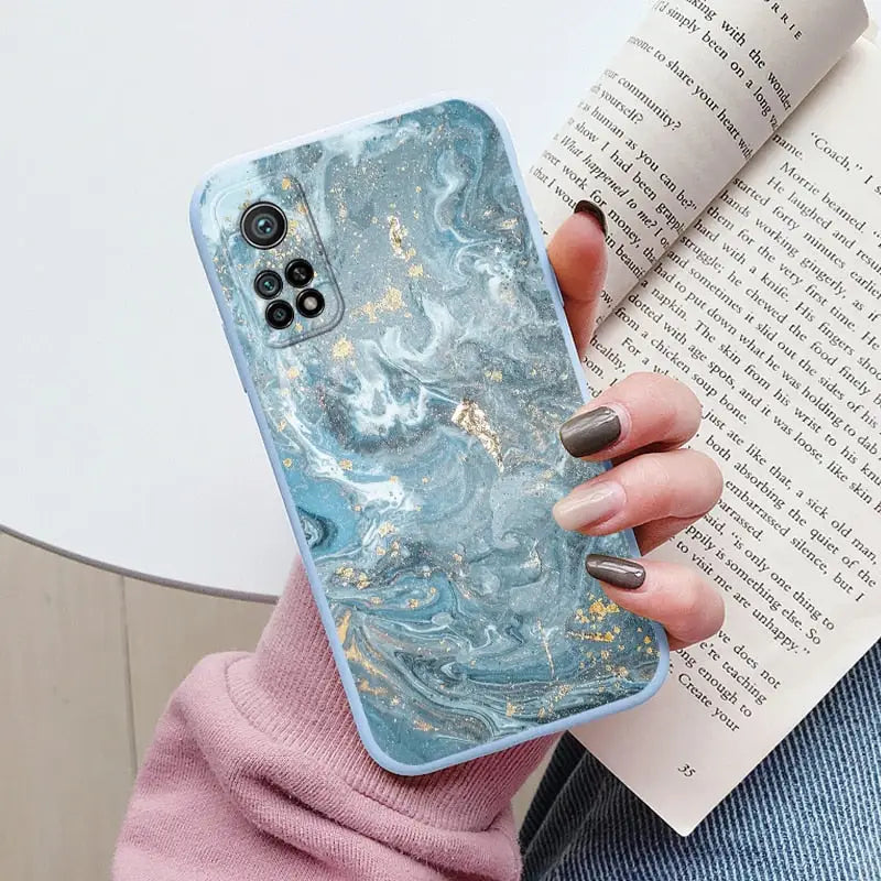a woman holding a book and a phone case