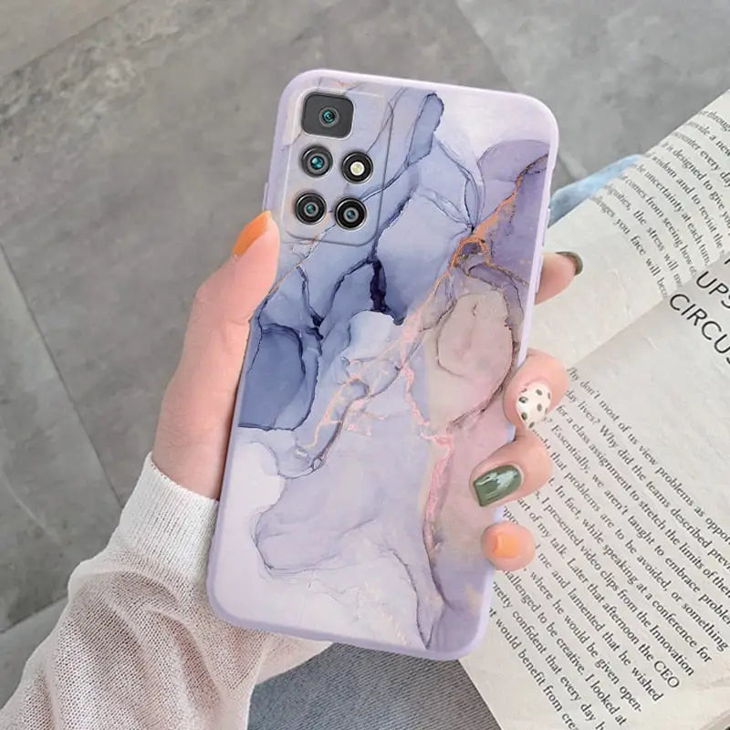 a woman holding a phone case with a marble pattern