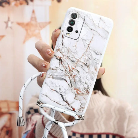 a woman holding a white phone case with marble pattern