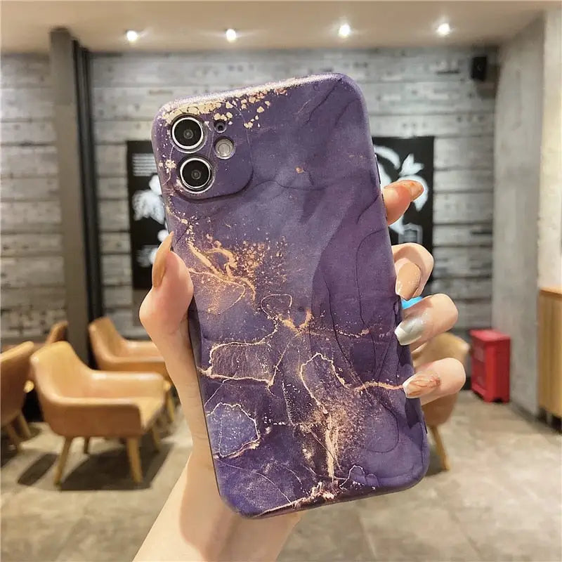 a purple marble phone case with a gold glitter effect