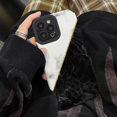 a woman holding a phone case with a marble pattern